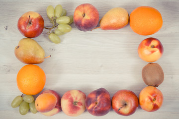 Frame of nutritious fruits as healthy dessert containing vitamins and minerals, place for text on white board