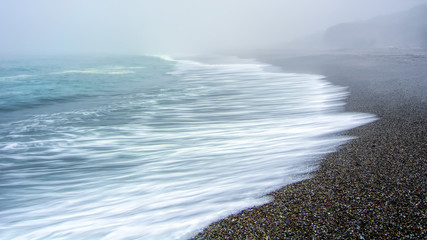 Long exposure waves breaking on the California coast large copy space