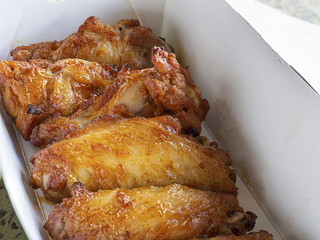 Close up of Fried chicken wings in a delivery paper box