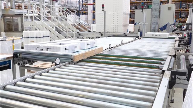 Industrial time-lapse, boxes move along conveyor