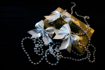 Christmas gift decoration with bows and silver pearls with black background