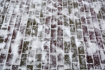 Paving slabs with snow in winter 