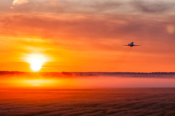 Fototapeta na wymiar Picturesque dawn with a fog at the airport. Takeoff of a private jet