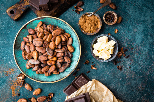 Cocoa. Cocoa beans, dark bitter chocolate chunks, cacao butter and cocoa powder. Cocoa  background