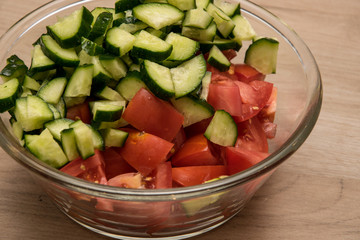 Sliced cucumbers and tomatoes. Ingredients for salad preparation.