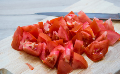 Pieces of chopped tomato on the board.