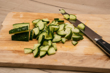 Sliced cucumber on a wooden board.