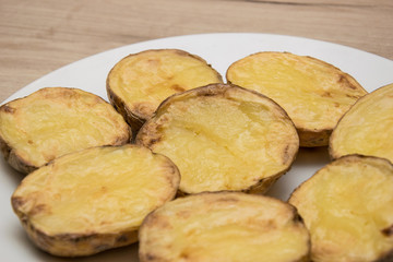 Halves of baked potatoes on a white plate.