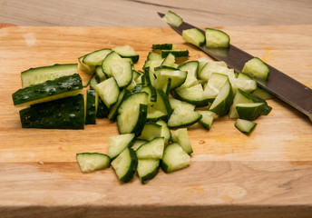 Sliced cucumber on a wooden board.