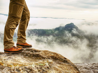 Man hiker legs with windproof trousers and hiking boots