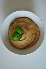 hummus in the white plate. hummus with basil