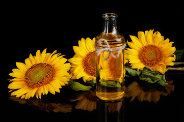 Sunflowers with oil on black background