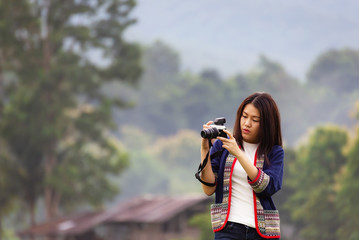 Traveler women taking photo with old fashioned camera. background the nature field rice .Happy tourist woman enjoy and relax serenity vacation. Lifestyle and Travel