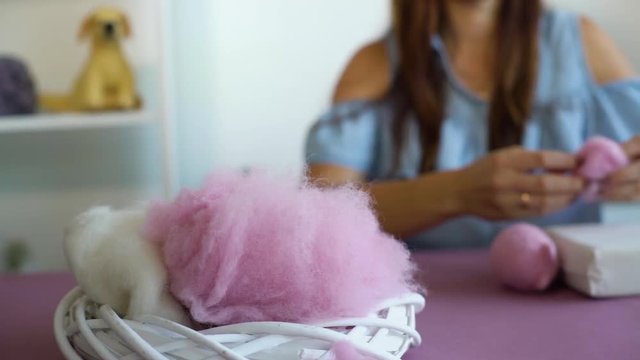 young caucasian woman making wool dry felting tutorial. female showing needle felted toy master class. Hobbies, handmade, crafting, leisure, teaching, education, creativity, design concept