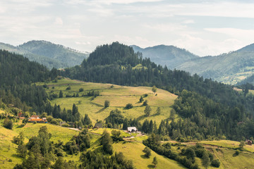 Landscape view on mountains, hills and meadow in village in Tara national par in Serbia - obrazy, fototapety, plakaty