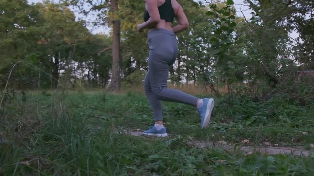 Overweight woman trying to lose weight and running in the park, slow motion