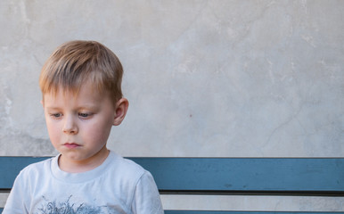 Little boy with unhappy expression.