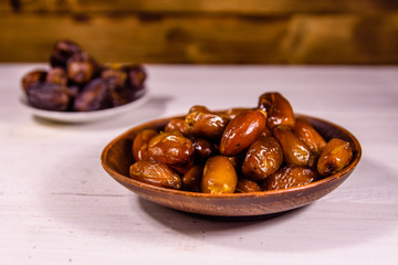 Date fruits on the white wooden table
