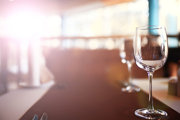glass of white wine in the restaurant / white wine in the interior of the restaurant a table with glasses of wine, a romantic summer