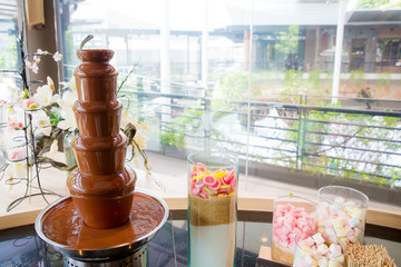 Close up chocolate fountain for fondue. Sweets of Swiss. chocolate melt for dipping. image for background, wallpaper, copy space and menu list.