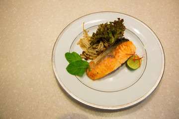 Top view of steak salmon and salad served on luxury white dish. healthy food. clean food concept. salmon high omega 3. image for background, wallpaper,menu list and copy space.