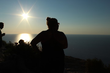 Woman silhouette at sunset in Ibiza