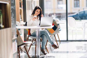 Beautiful brunette enjoying coffee and working
