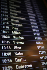 Fototapeta premium board airport departures schedule / departure of city airplanes flights font at the airport