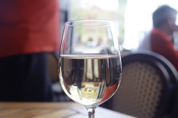 glass of white wine in the restaurant / white wine in the interior of the restaurant a table with glasses of wine, a romantic summer