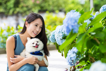Woman with her pomeranian dog at outdoor park