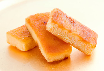 pieces of marzipan on golden background