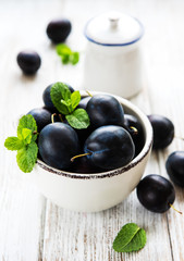 Bowl with fresh plums