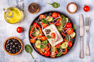 Greek salad of fresh cucumber, tomato, sweet pepper, spinach, red onion, feta cheese and olives