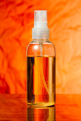 bottle with oil spray for the body is on the table