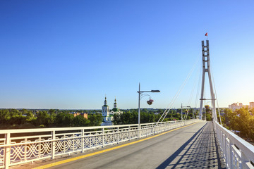 Fototapeta na wymiar The view of pedestrian “Bridge of Lovers” in the city of Tyumen, Russia. 