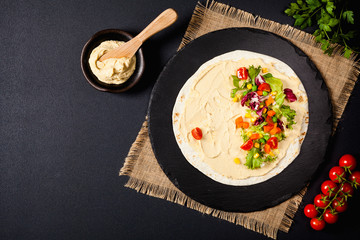 Tortilla with vegetables and hummus with chickpeas