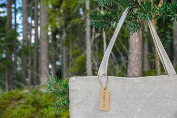 Organic eco shopping bag. Canvas tote bag in pine tree. Eco textile tag. Green forest, nature in...