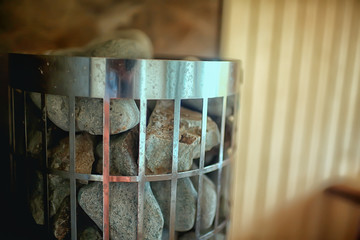 sauna stones / hot stones for water supply, steam on the stones in the sauna, spa concept, hot relaxation