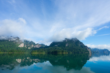 Morning mountain landscape and mist with mountains reflected in the water