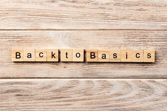 back to basics word written on wood block. back to basics text on table, concept
