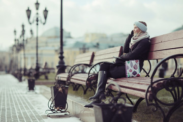 woman on a bench in a winter city