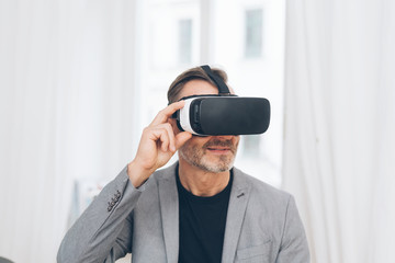 Mature man using virtual reality headset