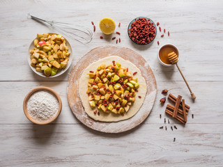 hands make dough Apple pie or Goji berry
