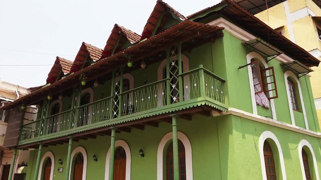 The camera tilts down as it displays a iridescent Indian building