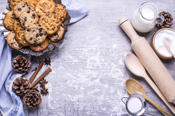 Delicious freshly baked homemade cookies and products for baking on a gray wooden table. Christmas concept. Flat lay