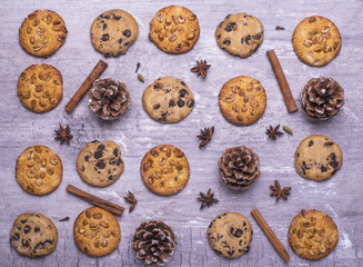 Christmas pattern with homemade delicious cookies, cinnamon, anice on a wooden gray table. Flat lay