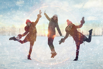 young women walking and having fun in the winter in the snow field