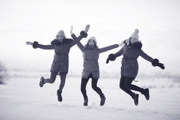 Fototapeta na wymiar group of girls winter nature fun jump