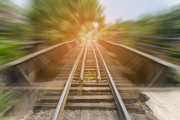 Fototapeta na wymiar railway bridge with motion blur effect over the canal - railroad landscape