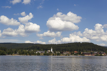 Heap clouds in the blue sky over the Titisee in the Black Forest